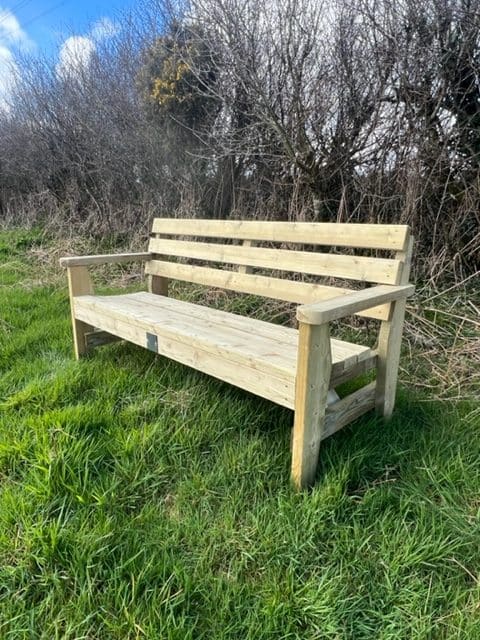 A 6ft handmade timber garden bench with an arched seat