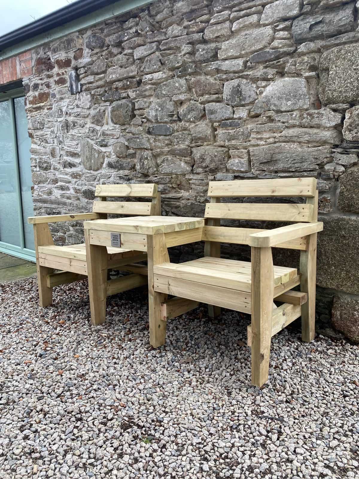 A companion chair, two timber seats joined by a side table