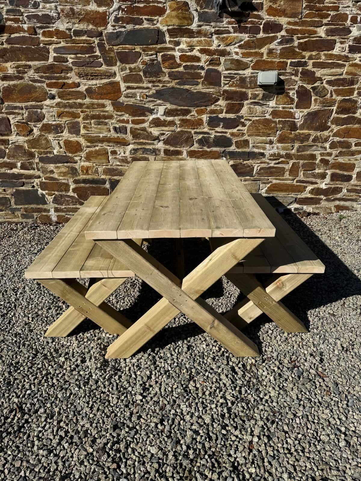 A cross-leg X table with two benches in heavy-duty timber