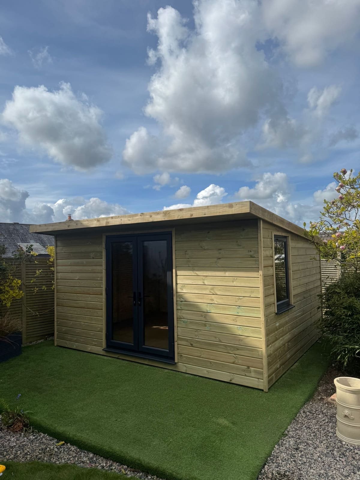 A timber garden room at golden hour